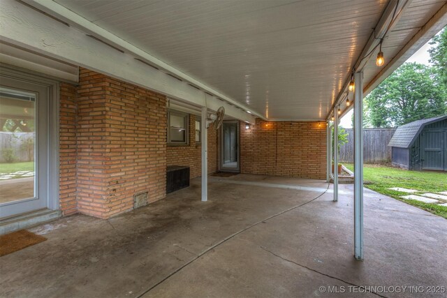view of patio featuring a storage shed, an outbuilding, and fence