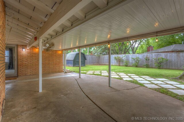 view of patio / terrace with a shed and an outbuilding