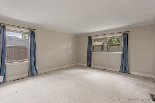 unfurnished room with carpet flooring, ornamental molding, and baseboards