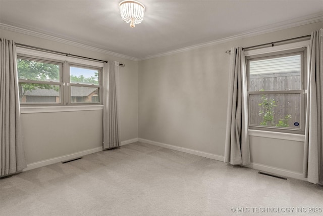 carpeted spare room with crown molding and baseboards