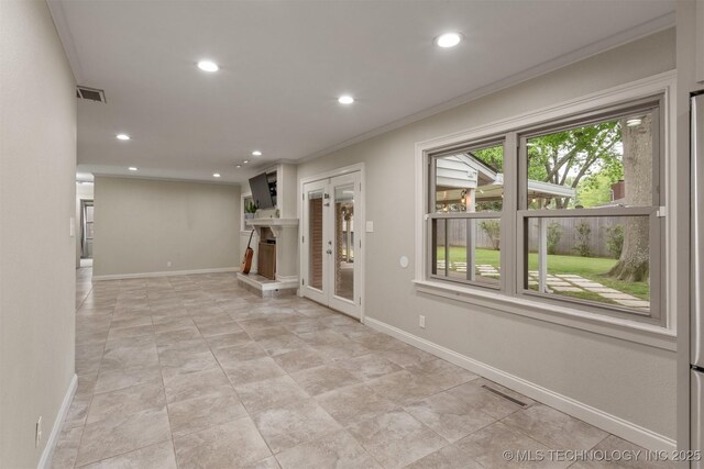 unfurnished living room with recessed lighting, crown molding, and baseboards