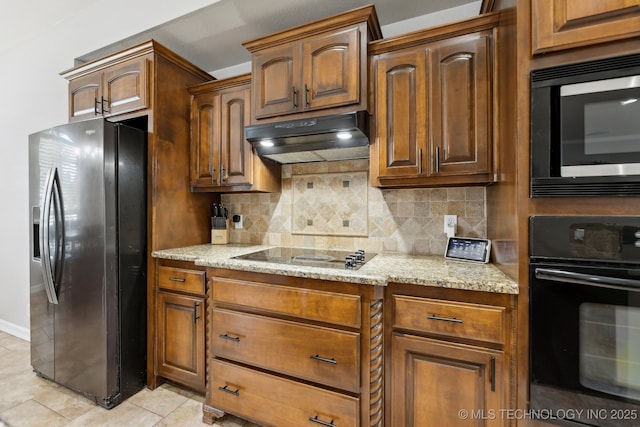 9401 N 95th E Pl, Owasso, OK 74055 - kitchen featuring black appliances, backsplash, under cabinet range hood, light stone counters, and light tile patterned flooring