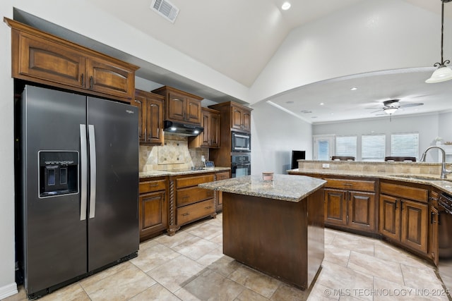 9401 N 95th E Pl, Owasso, OK 74055 - kitchen featuring black appliances, a sink, under cabinet range hood, lofted ceiling, and decorative backsplash
