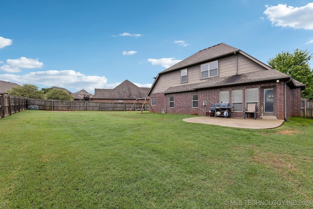9401 N 95th E Pl, Owasso, OK 74055 - rear view of property with a patio area, brick siding, a playground, and roof with shingles