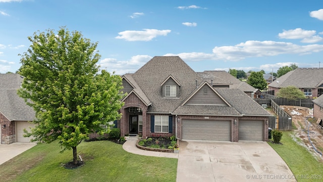 9401 N 95th E Pl, Owasso, OK 74055 - view of front of home featuring an attached garage, concrete driveway, roof with shingles, and brick siding