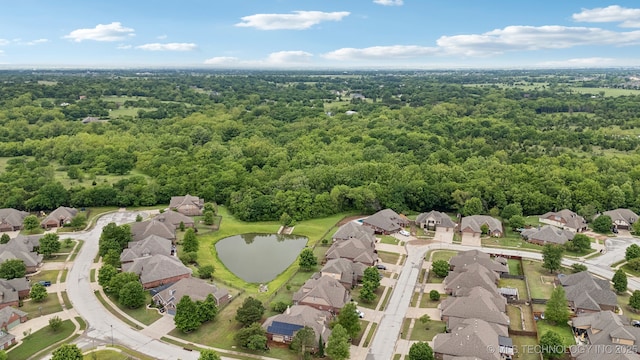 9401 N 95th E Pl, Owasso, OK 74055 - aerial perspective of suburban area featuring a heavily wooded area and a nearby body of water