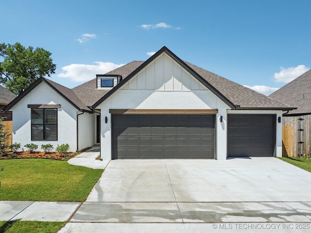 view of front of house with an attached garage, driveway, a shingled roof, and stucco siding