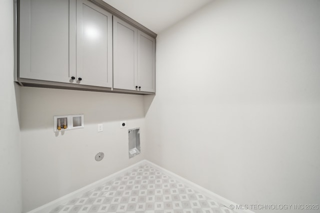 clothes washing area featuring cabinet space, hookup for an electric dryer, washer hookup, baseboards, and hookup for a gas dryer