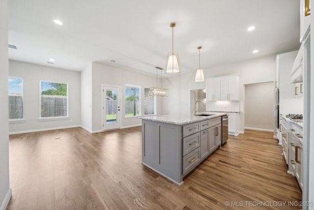 kitchen featuring gray cabinetry, a sink, stainless steel dishwasher, light wood-style floors, and recessed lighting
