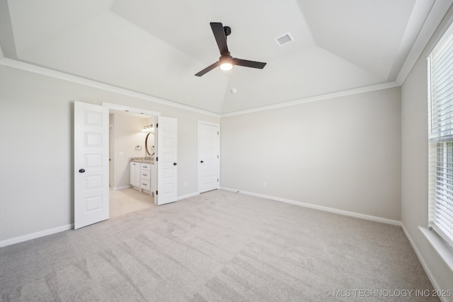 unfurnished bedroom featuring vaulted ceiling, light carpet, connected bathroom, ceiling fan, and baseboards