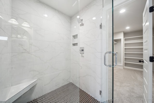 bathroom featuring a stall shower, recessed lighting, and a spacious closet