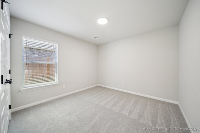 carpeted empty room with baseboards