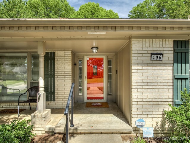 property entrance featuring brick siding