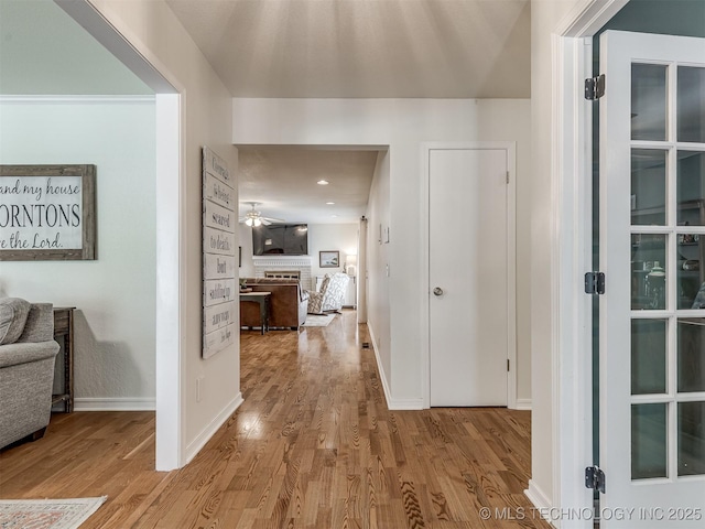 hall with wood finished floors and baseboards
