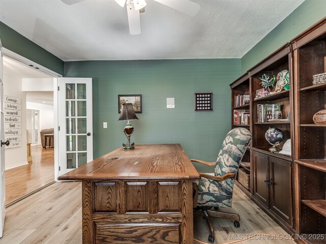 office space with light wood-style floors and ceiling fan