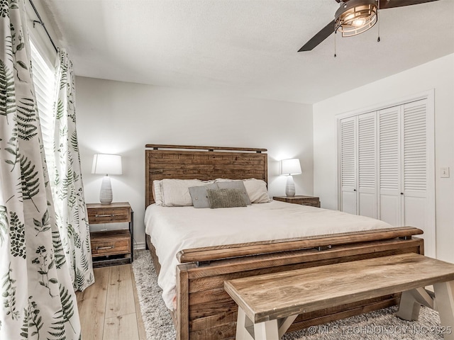 bedroom with hardwood / wood-style flooring, a closet, and ceiling fan