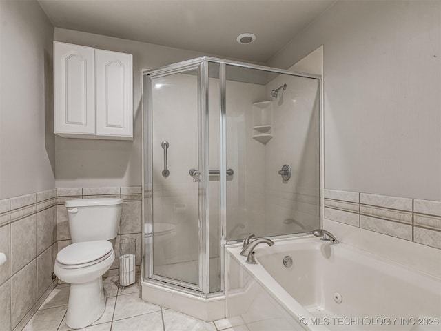 bathroom featuring a shower stall, a bath, toilet, tile patterned flooring, and tile walls
