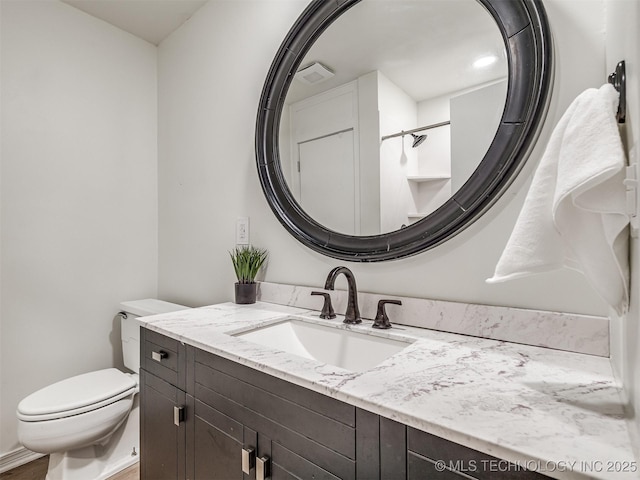 bathroom with vanity and toilet