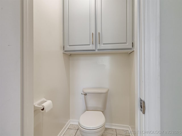 bathroom featuring tile patterned floors, baseboards, and toilet