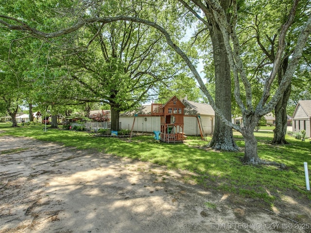 view of grassy yard featuring a playground