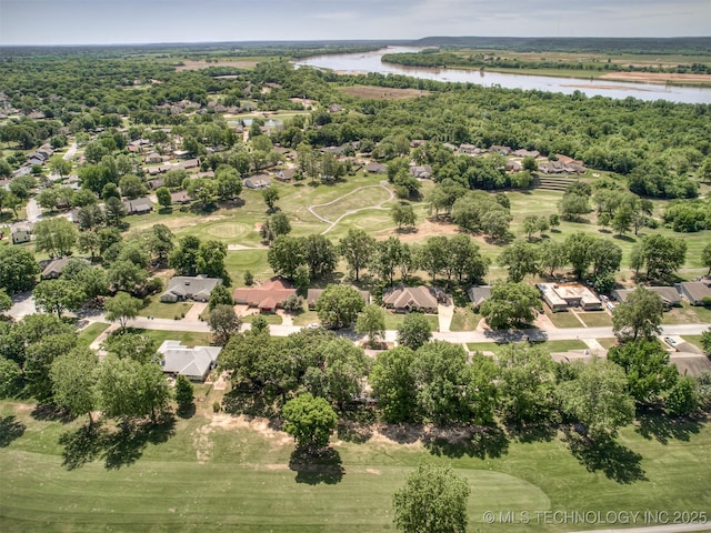 aerial view of residential area with a large body of water and a golf course