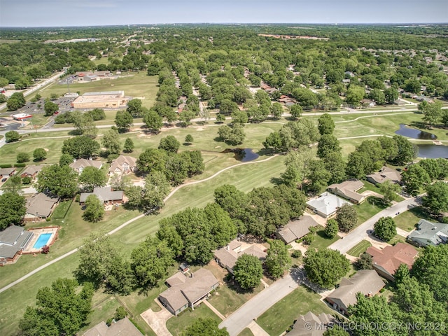 aerial view of residential area with a large body of water and a golf course