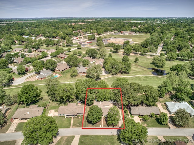 aerial view of residential area with property parcel outlined, a large body of water, and a local golf course