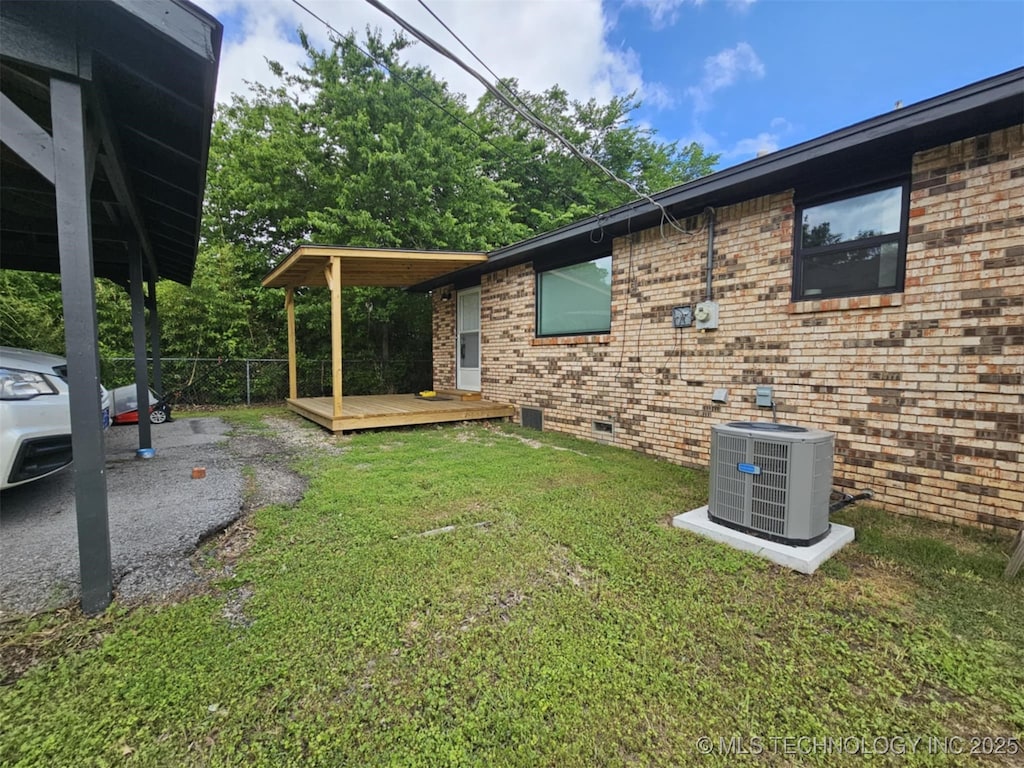view of property exterior with cooling unit, crawl space, a deck, and brick siding