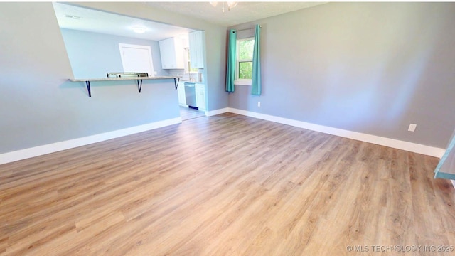917 Fairway, Sulphur, OK 73086 - unfurnished living room with light wood-style flooring and baseboards