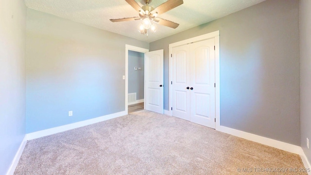 917 Fairway, Sulphur, OK 73086 - unfurnished bedroom featuring carpet, a closet, baseboards, ceiling fan, and a textured ceiling