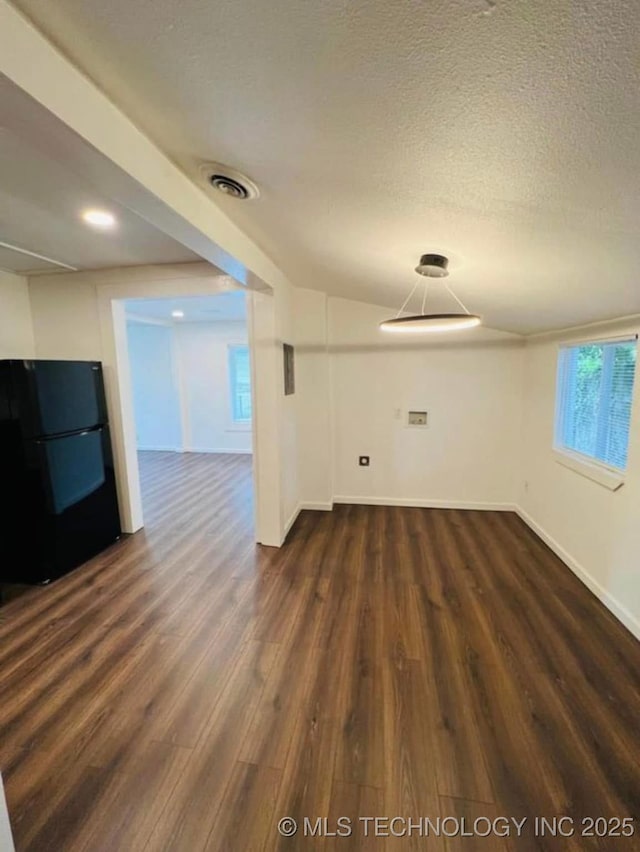 2643 E Haskell St, Tulsa, OK 74110 - spare room featuring dark wood-style floors, baseboards, and a textured ceiling