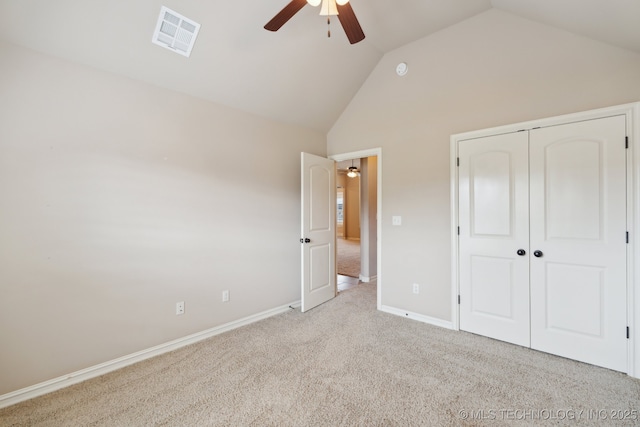 unfurnished bedroom featuring carpet floors, baseboards, a closet, a ceiling fan, and high vaulted ceiling