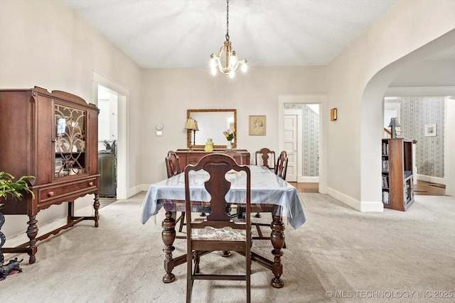 1032 E Mcleod Ave, Sapulpa, OK 74066 - dining space with light carpet, arched walkways, and a chandelier