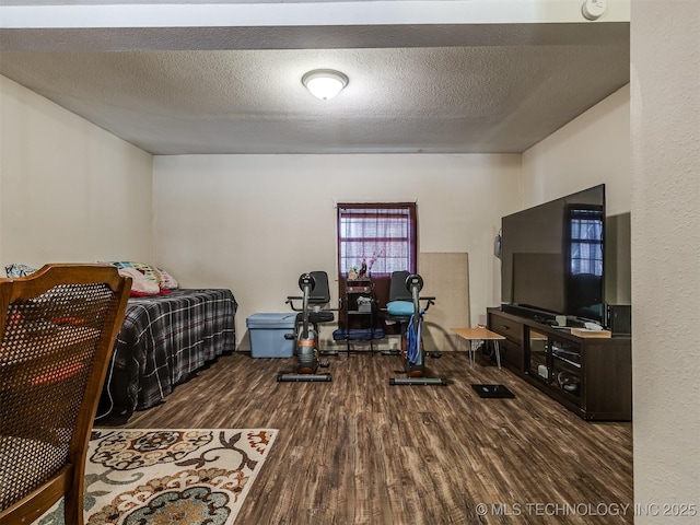 940 N Ross Ave, Dewey, OK 74029 - bedroom featuring wood finished floors and a textured ceiling