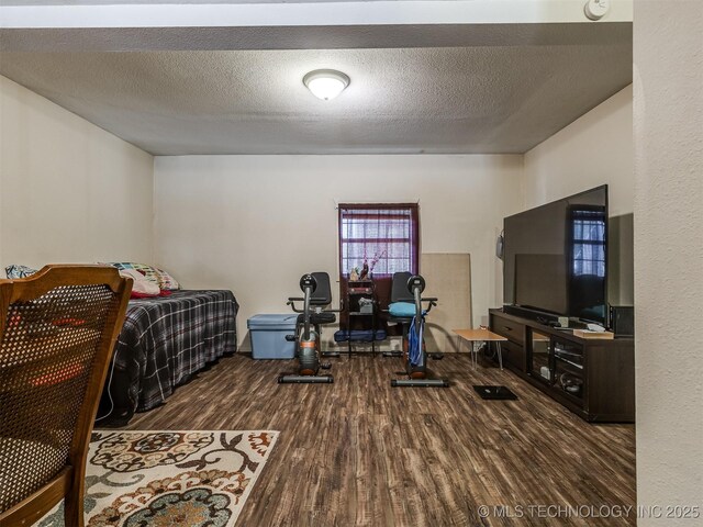 940 N Ross Ave, Dewey, OK 74029 - bedroom featuring wood finished floors and a textured ceiling