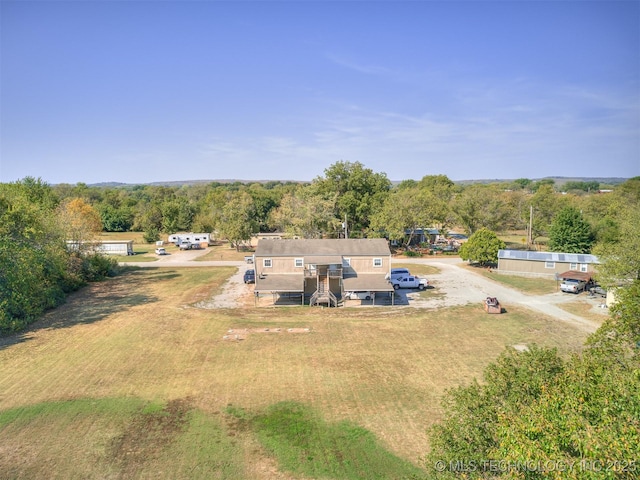 940 N Ross Ave, Dewey, OK 74029 - aerial view of property and surrounding area with a heavily wooded area