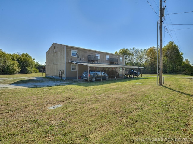 940 N Ross Ave, Dewey, OK 74029 - rear view of property featuring a carport and a yard