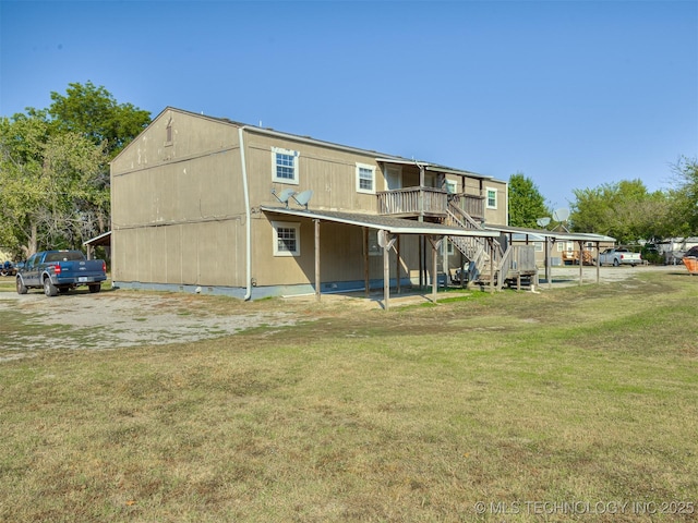 940 N Ross Ave, Dewey, OK 74029 - back of house with stairs, a wooden deck, and a lawn