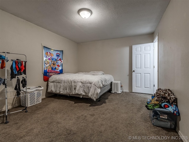 940 N Ross Ave, Dewey, OK 74029 - bedroom with a textured ceiling, carpet, and baseboards