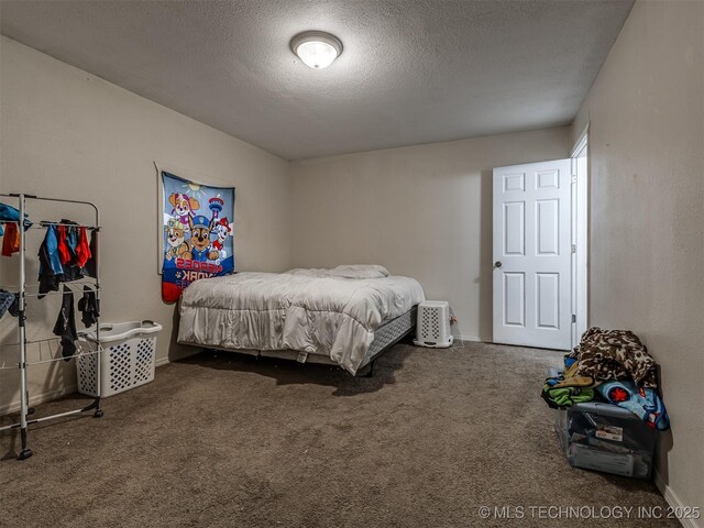 940 N Ross Ave, Dewey, OK 74029 - bedroom with a textured ceiling, carpet, and baseboards