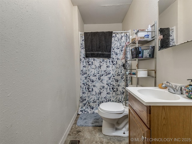940 N Ross Ave, Dewey, OK 74029 - bathroom with vanity, baseboards, toilet, a shower with shower curtain, and a textured wall