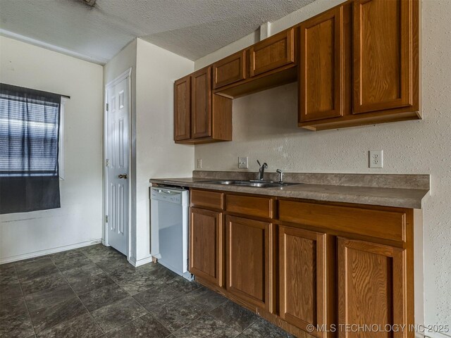 940 N Ross Ave, Dewey, OK 74029 - kitchen featuring dishwasher, a sink, dark countertops, and brown cabinetry