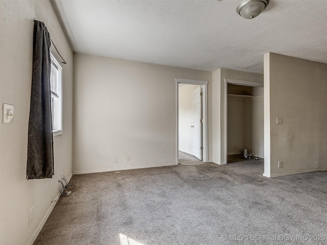 940 N Ross Ave, Dewey, OK 74029 - unfurnished bedroom with a textured ceiling, carpet floors, baseboards, and a closet