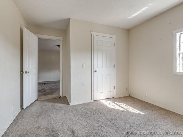940 N Ross Ave, Dewey, OK 74029 - unfurnished bedroom with carpet flooring and baseboards