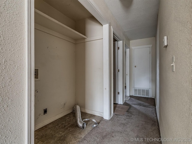 940 N Ross Ave, Dewey, OK 74029 - clothes washing area featuring electric dryer hookup, hookup for a washing machine, a textured ceiling, baseboards, and a textured wall