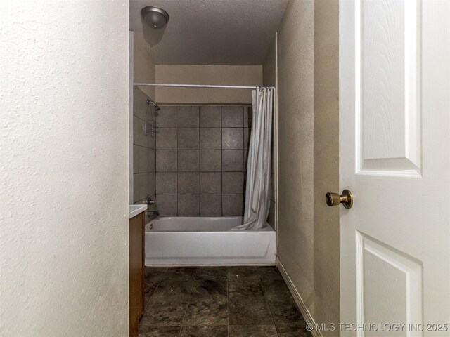 940 N Ross Ave, Dewey, OK 74029 - bathroom with a textured wall, shower / bath combo, vanity, and baseboards