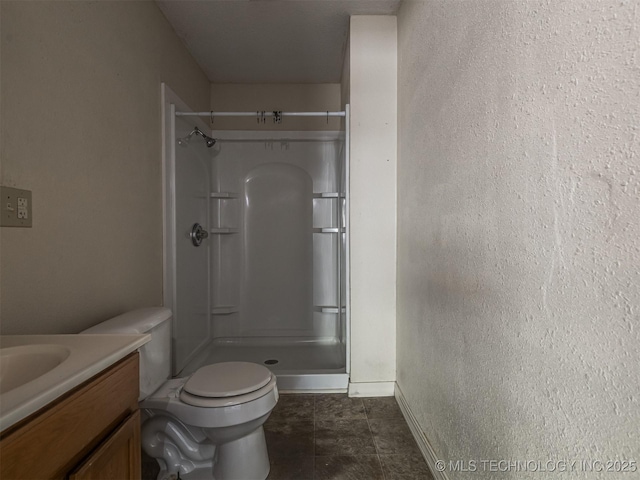 940 N Ross Ave, Dewey, OK 74029 - bathroom featuring a shower stall, vanity, baseboards, toilet, and tile patterned flooring