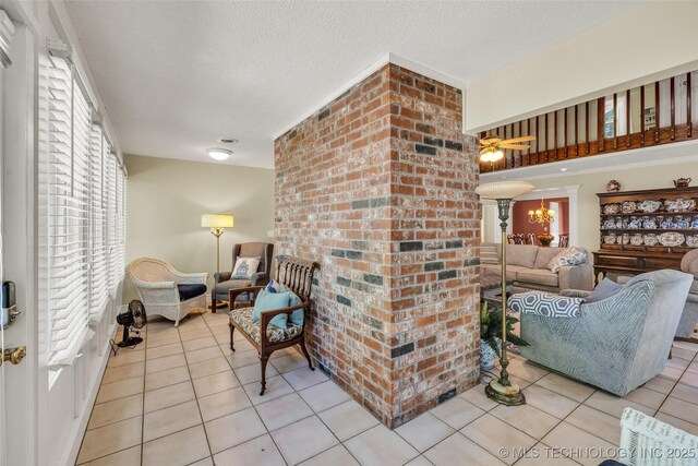 3112 Shore Dr, Grove, OK 74344 - living room featuring light tile patterned floors, a textured ceiling, and ceiling fan