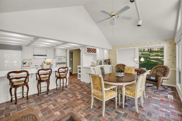 3112 Shore Dr, Grove, OK 74344 - dining room featuring a ceiling fan, brick flooring, and high vaulted ceiling