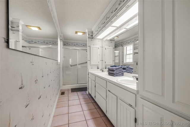 3112 Shore Dr, Grove, OK 74344 - bathroom featuring a shower stall, double vanity, tile patterned floors, wallpapered walls, and a textured ceiling
